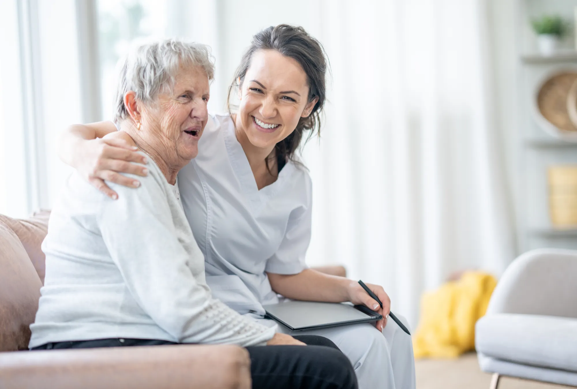 Respite care services in Michigan - caretaker and elderly woman smiling and hugging